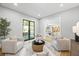 Bright living room with four chairs, contemporary art and a sliding glass door to the backyard at 4785 Longchamps Dr, Sandy Springs, GA 30319