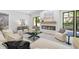 Elegant living room featuring modern fireplace, neutral tones, and access to the outdoor area at 4785 Longchamps Dr, Sandy Springs, GA 30319
