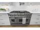 Close-up of stainless steel double oven, surrounded by white cabinetry at 4785 Longchamps Dr, Sandy Springs, GA 30319