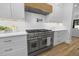 Gourmet kitchen features a stainless steel oven, range hood, and white cabinetry at 4785 Longchamps Dr, Sandy Springs, GA 30319