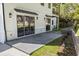 The patio has stone flooring, sleek lighting fixtures, and a white exterior, blending comfort and style at 4785 Longchamps Dr, Sandy Springs, GA 30319