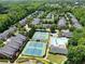 Aerial view of tennis courts and swimming pool surrounded by townhomes and mature trees at 4912 Waters Edge Trl, Roswell, GA 30075