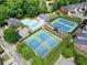 Aerial view of community pool and tennis courts nestled among lush trees and well-maintained homes at 4912 Waters Edge Trl, Roswell, GA 30075