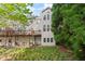 Townhome backyard with walkout deck and lush greenery, surrounded by mature trees at 4912 Waters Edge Trl, Roswell, GA 30075