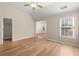 Bright bedroom with vaulted ceilings, a fan, wood floors, and walk-in closet at 4912 Waters Edge Trl, Roswell, GA 30075