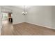 Dining area with wood floors, chandelier, and access to the kitchen, perfect for entertaining at 4912 Waters Edge Trl, Roswell, GA 30075