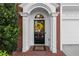 A welcoming front entryway with a decorative wreath, white columns, and classic brick detailing at 4912 Waters Edge Trl, Roswell, GA 30075