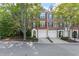Charming brick townhome featuring a two-car garage, neat landscaping, and classic architectural details at 4912 Waters Edge Trl, Roswell, GA 30075