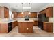 Charming kitchen features stainless steel appliances, wood cabinets, a center island, and eat-in area at 4912 Waters Edge Trl, Roswell, GA 30075