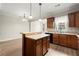 Bright kitchen features an island, plenty of counter space, wood cabinets, and updated stainless steel appliances at 4912 Waters Edge Trl, Roswell, GA 30075