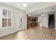 Inviting living area adjacent to a kitchen features natural light, new flooring and a stairwell to the upper level at 4912 Waters Edge Trl, Roswell, GA 30075
