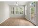 Bright sunroom featuring plantation shutters, a ceiling fan, and a glass door that provides natural light and access to outdoors at 4912 Waters Edge Trl, Roswell, GA 30075