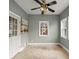 Bright sunroom with ceiling fan, tile floors, and access to back yard through glass door at 4912 Waters Edge Trl, Roswell, GA 30075