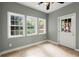 Bright sunroom with tile floors, ceiling fan, and view of back yard through windows at 4912 Waters Edge Trl, Roswell, GA 30075