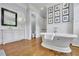 Elegant bathroom with standalone tub, double vanity, and warm hardwood floors at 690 Ebenezer Rd, Milton, GA 30075