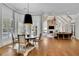 Open dining room with hardwood floors, large windows, and stylish lighting fixture at 690 Ebenezer Rd, Milton, GA 30075