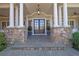 Inviting front porch with stone pillars and stylish double doors at 690 Ebenezer Rd, Milton, GA 30075