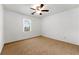 This bedroom features neutral carpeting and a bright window at 1170 Moseley Rd, Stockbridge, GA 30281