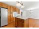 Eat-in kitchen featuring an island, stainless steel fridge, and wood cabinets at 1170 Moseley Rd, Stockbridge, GA 30281