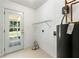 Functional utility room with a door to the outside, creating a practical space for laundry and storage at 1170 Moseley Rd, Stockbridge, GA 30281