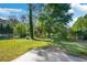 Private backyard featuring mature trees, greenery, and a lush lawn, perfect for outdoor activities at 4861 Alcan Rd, Powder Springs, GA 30127