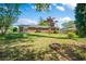 Spacious, well-maintained backyard featuring green grass, trees, a brick patio and a fire pit, perfect for outdoor enjoyment at 4861 Alcan Rd, Powder Springs, GA 30127