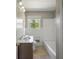 Functional bathroom with a vanity, toilet, combined shower, and a window for natural light at 4861 Alcan Rd, Powder Springs, GA 30127