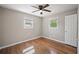 Bright bedroom featuring hardwood floors, a ceiling fan, and two windows offering lots of natural light at 4861 Alcan Rd, Powder Springs, GA 30127