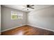 Cozy bedroom with hardwood flooring, a ceiling fan, and a window offering lots of natural light at 4861 Alcan Rd, Powder Springs, GA 30127