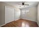 Bedroom featuring hardwood floors, a ceiling fan, a closet, and a window for lots of natural light at 4861 Alcan Rd, Powder Springs, GA 30127