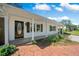 Inviting covered front porch with a decorative door, flanked by plants, creating a welcoming entrance at 4861 Alcan Rd, Powder Springs, GA 30127
