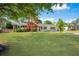 Charming home featuring a well-manicured front yard, a brick walkway, and a welcoming porch and black shutters at 4861 Alcan Rd, Powder Springs, GA 30127