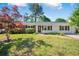 Charming house with a well-kept lawn and a mix of shrubs and trees adding to the curb appeal at 4861 Alcan Rd, Powder Springs, GA 30127