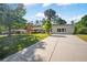 Inviting one-story home featuring a long driveway and lush green lawn leading to the front entrance at 4861 Alcan Rd, Powder Springs, GA 30127