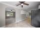 Open concept kitchen with stainless steel refrigerator and view to the living room at 4861 Alcan Rd, Powder Springs, GA 30127