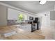 Updated kitchen featuring white cabinets and mosaic backsplash at 4861 Alcan Rd, Powder Springs, GA 30127