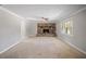 Spacious living room featuring a stone fireplace, ceiling fan, and large windows at 4861 Alcan Rd, Powder Springs, GA 30127