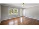 Bright living room with hardwood floors, a large window for natural light, and a modern color scheme at 4861 Alcan Rd, Powder Springs, GA 30127