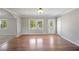 Open living space with hardwood floors, a large window, and fresh, neutral paint, creating an airy feel at 4861 Alcan Rd, Powder Springs, GA 30127