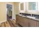 Modern bathroom with a double vanity, granite countertop, and well-lit mirrors at 5201 Skyline Dr, Stone Mountain, GA 30083