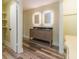 Bathroom featuring double vanity sinks, granite countertops, and lighted mirrors at 5201 Skyline Dr, Stone Mountain, GA 30083