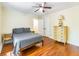 Bedroom featuring hardwood floors, a queen-sized bed, and a vintage dresser with ample closet space at 5201 Skyline Dr, Stone Mountain, GA 30083