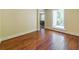 Bright bedroom featuring hardwood floors and a large window overlooking a natural setting at 5201 Skyline Dr, Stone Mountain, GA 30083