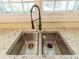 Close-up of a stainless steel kitchen sink with a granite countertop and a modern faucet at 5201 Skyline Dr, Stone Mountain, GA 30083