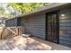Back deck entrance of home with metal security door, pet bed, and access to outdoor relaxation at 5272 Cumberland Way, Stone Mountain, GA 30087