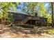 Spacious backyard with mature trees and a raised wooden deck providing an inviting outdoor living space at 5272 Cumberland Way, Stone Mountain, GA 30087