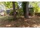 Large wooded backyard featuring mature trees, offering a private outdoor space for relaxation and activities at 5272 Cumberland Way, Stone Mountain, GA 30087