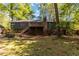 A spacious backyard view with a raised deck, surrounded by mature trees, offering a private outdoor space at 5272 Cumberland Way, Stone Mountain, GA 30087