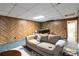 Relaxing finished basement with wood paneling, carpet, sofa, and wet bar at 5272 Cumberland Way, Stone Mountain, GA 30087