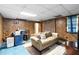 Cozy finished basement with wood paneling, carpet, sofa, and wet bar at 5272 Cumberland Way, Stone Mountain, GA 30087